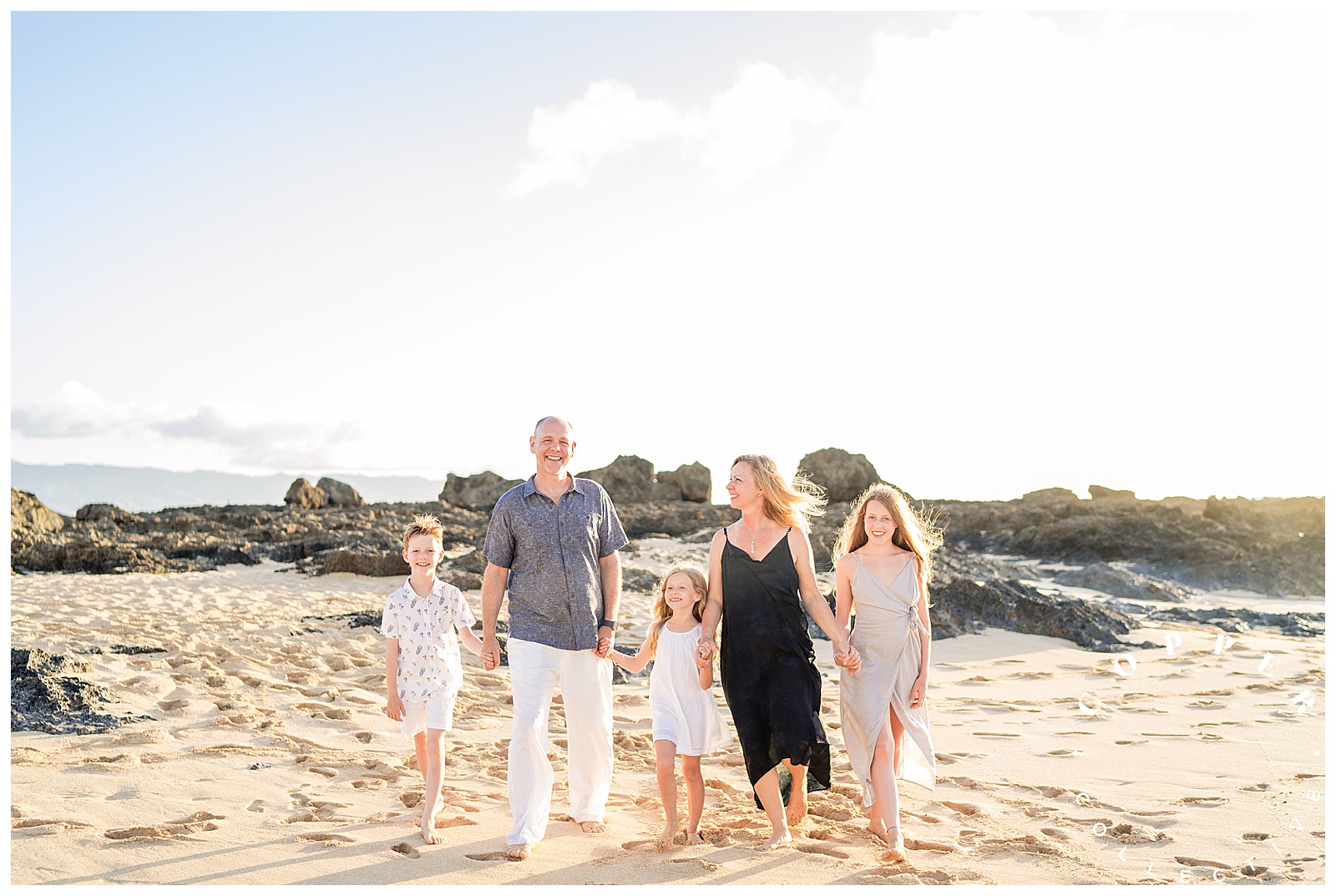 Family of five walking on the beach in Hawaii